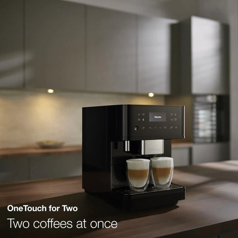 Sleek Fully Automatic Coffee And Espresso Machine With Silent Steel Grinding Chamber For Killer Cup Creations And Rich Silky Milk Foam For Serious Home Baristas brewing two coffees simultaneously in a modern kitchen.