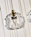 Modern Raindrop Pendant Lights Set Of 3 with brass round hanging lamps and clear crystal prisms, close-up of chandelier detail
