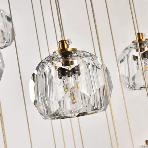 Modern Raindrop Pendant Lights Set Of 3 with brass round hanging lamps and clear crystal prisms, close-up of chandelier detail