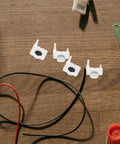 Four pieces of white silicone push button switches for easy installation in DIY repairs, part of 40 Piece Silicone Push Button Switch Replacement Keypad Membrane For Home Diy Repair And Emergency Stop Easy Install No Stress Swaps Big Time Durability For Worn Panels Knockout Quality Straight Up Reliable Setup That Simply Clicks In Perfectly.