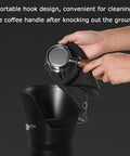 Heavy Hitter Floor Standing Coffee Knock Box With Self Draining Rubber Base Holds 6.8 Liters, cleaning coffee handle with towel.