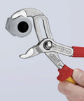 Cobra High Tech Water Pump Pliers 1000V Insulated With Tethered Attachment 10 Inch gripping a large nut