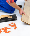 Installer using Beefy Pro Grade 4 In 1 Laminate And Vinyl Flooring Installation Kit with spacers, pull bar, and tapping block.