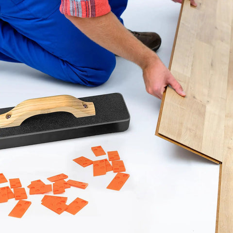 Installer using Beefy Pro Grade 4 In 1 Laminate And Vinyl Flooring Installation Kit with spacers, pull bar, and tapping block.