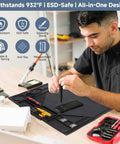 Man using Silicone Soldering Mat With Stand, 20x14 Inch ESD Safe Anti Static Workbench Pad, Heat Resistant for electronics repair.