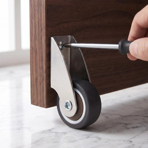 Installing a 2 Pack Low Profile Anti Sag Caster Wheel on furniture with a screwdriver for smooth movement.