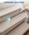 Using Dyson Dryer Vent Cleaner Kit With Lint Brush And Extension Hose For Deep Cleaning Of Dryer Vents And Lint Traps on carpeted stairs.