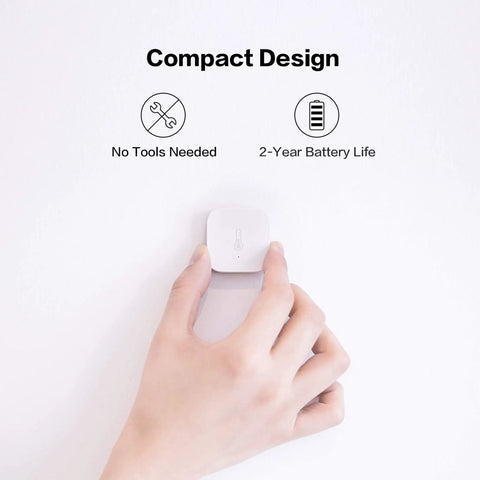 Hand holding Zigbee Temperature And Humidity Sensor For Home Automation With Wireless Thermometer Hygrometer Remote Monitoring