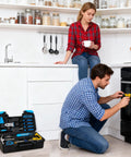 Person using tool from Grab And Go 39 Piece Basic Home Tool Set For DIYers with Quick Fixes in kitchen, toolbox visible on floor