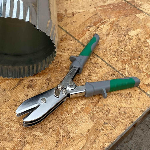 Five Blade Sheet Metal Crimping Tool With Soft Grip Handles And Safety Lock next to ductwork on wooden surface