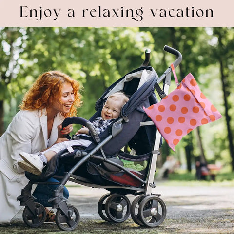 Coral Pink Polka Dot Wet Bag And Dry Bag For Beach And Pool Waterproof, Machine Washable And Reusable Swim Tote on a stroller