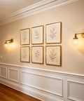 Vintage Double Sconce Wall Light With 5.9 Inch Clear Glass Globe illuminating hallway with framed art