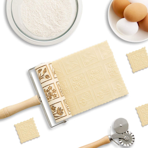 Mini Embossing Rolling Pin With Spring Flowers Design For Cookies, Pie Crusts, And Fondant placed beside flour and eggs