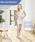Woman holding Three Step Folding Ladder Stool With Anti Slip Wide Pedals Aluminum Portable Lightweight Handy Everyday Use for Adults Multi Use At Home And Kitchen Black 330 Lbs Capacity, with a cat nearby indoors