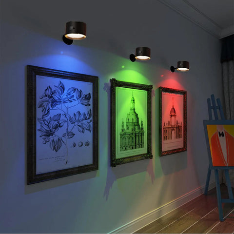 Magnetic Wall Sconce LED Light With 16 RGB Colors Dimmable 4 Pack illuminating framed art with blue, green, and red light.