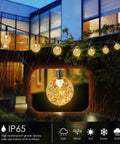 Battery Operated Globe Fairy Lights 16 Feet Waterproof With Timer And 8 Modes 30 LEDs illuminating a rainy outdoor patio