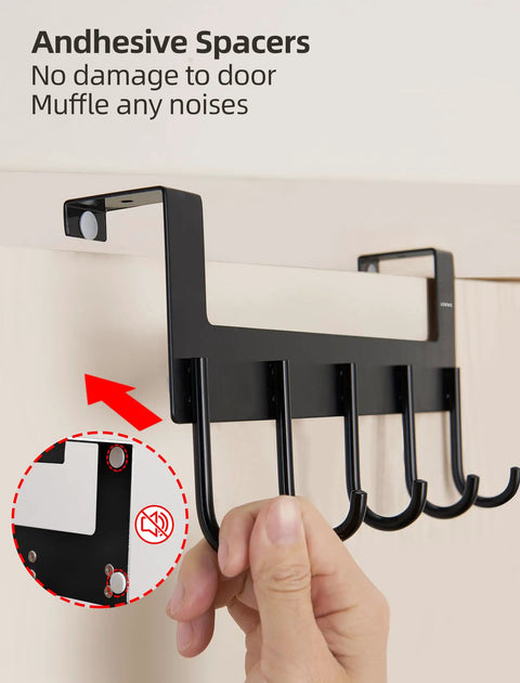 Over The Door Towel Rack With 5 Heavy Duty Aluminum Hooks being installed on door, matte black, adhesive spacers visible