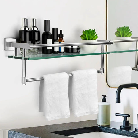 Brushed Nickel 20 Inch Glass Bathroom Shelf With Towel Bar, holding toiletries, mounted above a sink near a mirror.