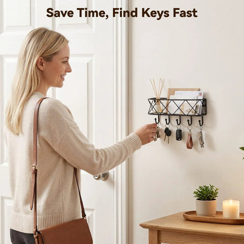 Woman using wall mounted key holder with five hooks and metal wire mesh mail basket, entryway organizer for keys and mail.