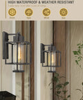 Outdoor Wall Sconce 2-Pack Farmhouse Exterior Lanterns in Black Finish With Bubble Glass Shades illuminating in rain