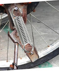 Grab This 8 Piece Small Compression Spring Kit With Hook Ends Perfect For Elevating Electric Vehicle Parking Stands And Securing Ladder Foot Supports To Keep Your Gear Rock Solid And Ready For Any Adventure. silver hook-end compression spring on rusty bike frame