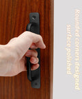 2 Pack Aluminum Alloy Sliding Barn Door Handle With Plate 128mm Center To Center Hole Spacing 5.9 Inch Total Length Black Finish Suitable For Kitchen Cabinet Bathroom And Closet Doors Durable And Easy To Install, installed on a wooden door with hand gripping.
