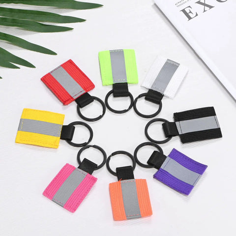 Assorted reflective safety keychain tags including Four Pack Fluorescent Green Reflective Safety Pendants for night activities.