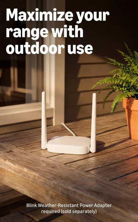 Sync Module XR+ on wooden table for Extended Range Wireless Outdoor Security Camera System With Four Cameras 10x Coverage Powered By XR Technology