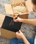 Person writes 'Thank You' on Black Bubble Mailers 6x10 Inch 100 Pack Padded Envelopes With Inner 6x9 Usable Size Opaque Waterproof Cushioning Mailers