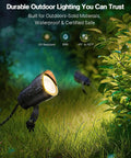 12W 2900K COB LED Low Voltage Landscape Spotlight illuminating a garden, showcasing its waterproof design and 36-degree beam focus.