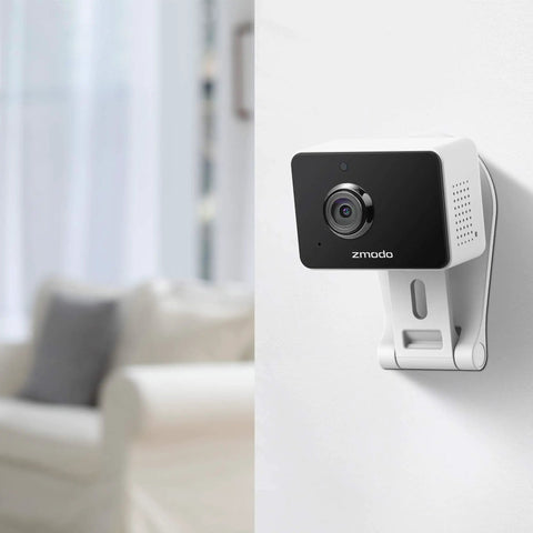 1080p Plug-In WiFi Indoor Security Camera With AI Motion Detection mounted on a wall in a living room setting