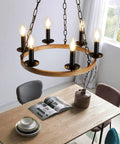 Farmhouse Wagon Wheel Chandelier With 6 Lights Industrial Round Candelabra Pendant Light Fixture hanging over dining table