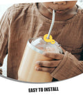 Child using Six Pack Silicone Straw Charm Adapters For Tumblers with yellow pendant at home gathering