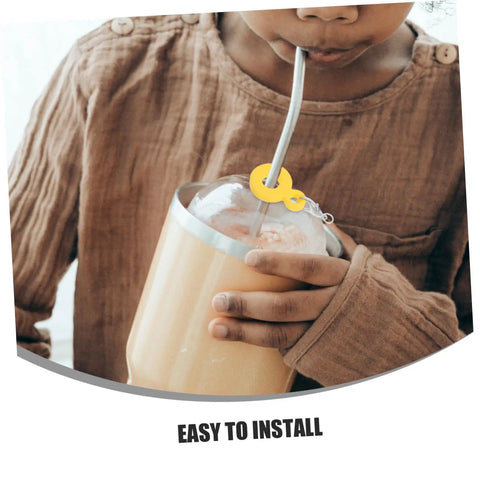 Child using Six Pack Silicone Straw Charm Adapters For Tumblers with yellow pendant at home gathering