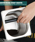 Hand holding Stainless Steel Espresso Knock Box With Rubber Bar for easy coffee grounds disposal, large capacity shown