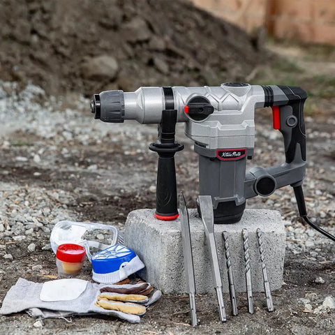 Beast 1200W Electric Rotary Hammer SDS Plus Drill with Swivel Handle, chisels, drill bits, gloves, glasses on outdoor concrete site