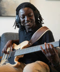 Person playing bass guitar with Dope Tone Wired Smart Guitar Headphone Amp With Custom Audio Drivers Noise Isolation