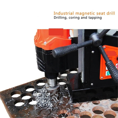 Heavy Duty Magnetic Drill Featuring Adjustable Speed And Forward Reverse Tapping Functions Delivering Smooth Steel Drilling And Industrial Metalwork That Goes Off Without A Hitch, working on a steel plate with metal shavings.