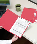 Letter Size Red Fastener Folders With Heavy Duty Embedded Straps And Assorted One Third Cut Tabs For Hustle Free Filing And Crisp Office Archiving Pack Of Fifty on desk with paperwork.
