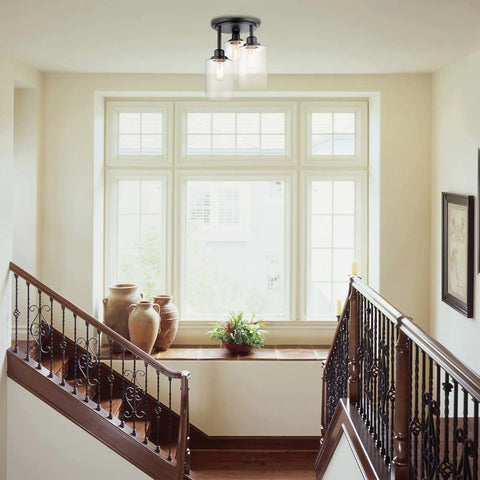 Three Light Industrial Tiered Matte Black Flush Mount Ceiling Light With Clear Glass Shade in a bright entryway