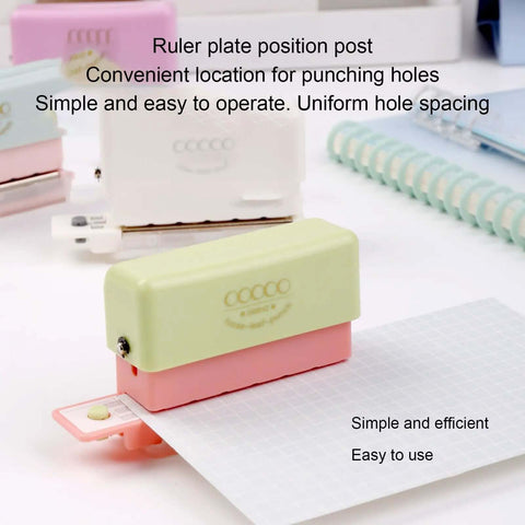 Grab And Go 5 Hole Paper Puncher Mini Handheld Circle Punch Tool punches a sheet with ruler guide for A4 A5 B5 sizes in an office setup