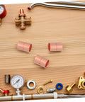 Sick 12 7 Mm Copper Pipe Couplings With Groove Stop for seamless welding, featuring copper fittings on a wooden surface.
