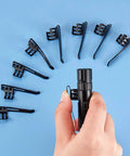 Hand holding penlight with 20 Pack Metal Flashlight Clips For Removable Accessories arranged in a circle on blue surface