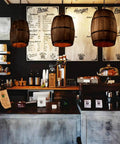 Antique Wood Wine Barrel Pendant Lamp Rustic Hanging Ceiling Light For Bar Kitchen And Cellar in café setting, three lamps visible