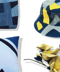 Blue patchwork pillows (3) with yellow artificial flowers.