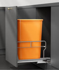 Premium Slick Under Cabinet Trash Pull Out Organizer Rack With Silent Soft Close Slides For Space Saving Kitchen Layout and Reliable Daily Maintenance, featuring an orange trash bin.