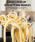 Close-up of 304 Stainless Steel Spaghetti Server With Teeth lifting noodles, ergonomic vacuum handle visible in modern kitchen.