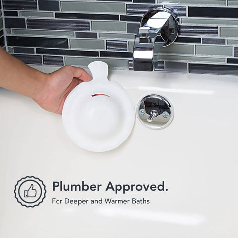 Overflow Drain Cover For Deeper Warmer Baths With No Fuss Suction Cups Universal Fit Spa Accessory Easy Install Adds Inches Of Water For A Deeper Cozy Soak Spa Vibe Works With Most Tubs being held by a hand near a bathtub overflow outlet.