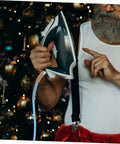 Man adjusting iron with High Temperature Steam Hose Replacement Tube For Steam Irons by Christmas tree.