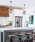 14 inch Crystal Pendant Light, 2-Light Antique Bronze Small Chandelier hanging over a kitchen island in a modern setting.